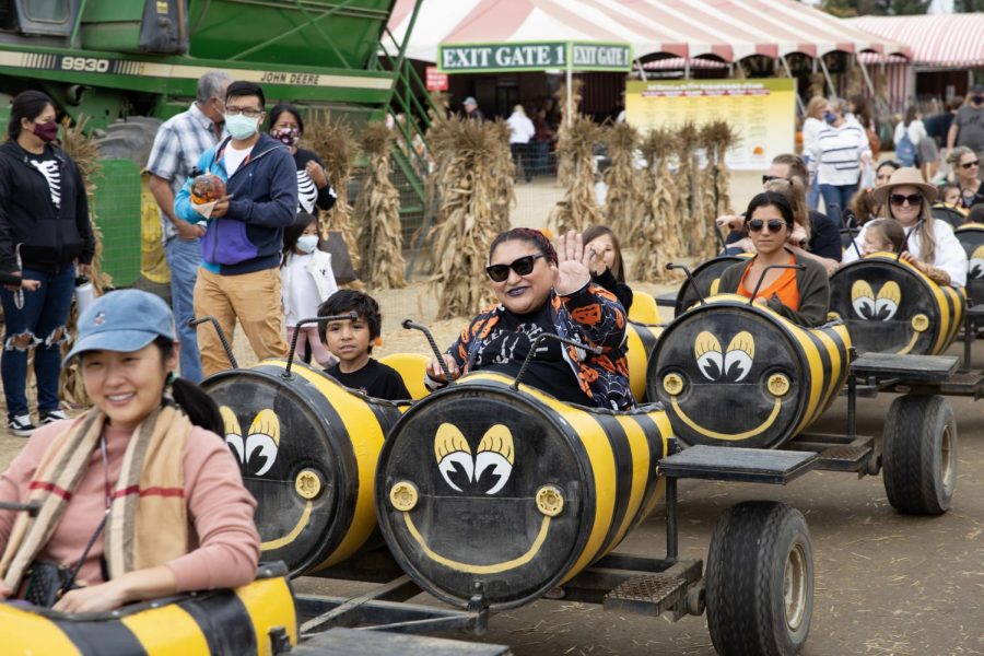 Ezra Guitierrez, 4 (center left) and Melody Guitierrez, 38 (center right) take a ride around the festival grounds at Underwood Family Farms during the Fall Harvest Festival on Saturday, October 23, 2021 in Moorpark, CA. Photo credit: Christopher Schmider