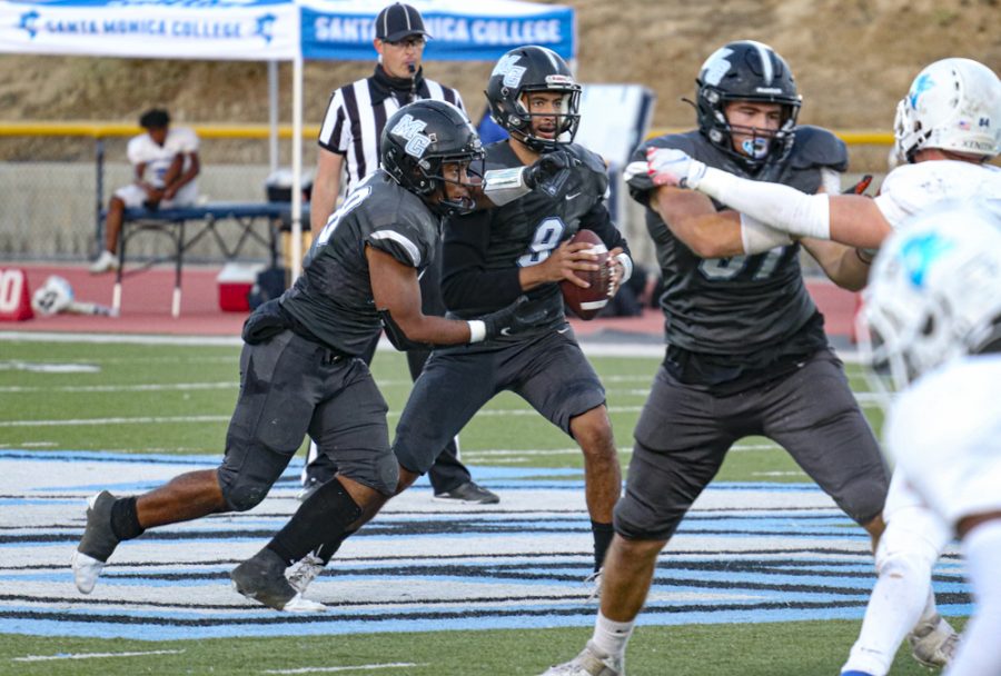 Raiders sophomore quarterback Trae Johnson runs an option play with freshman running back Donovan Davis in the first half. Johnson had a great game that led to a 44-41 Moorpark victory on Oct.16 in Moorpark, California. Photo credit: Hunter Deniaud