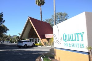 The Quality Inn & Suites sign and office building is slowly transformed into a new shelter on Tuesday, Nov. 2, 2021. This location will serve as the citys new permanent homeless shelter. Photo credit: Christina Mehr
