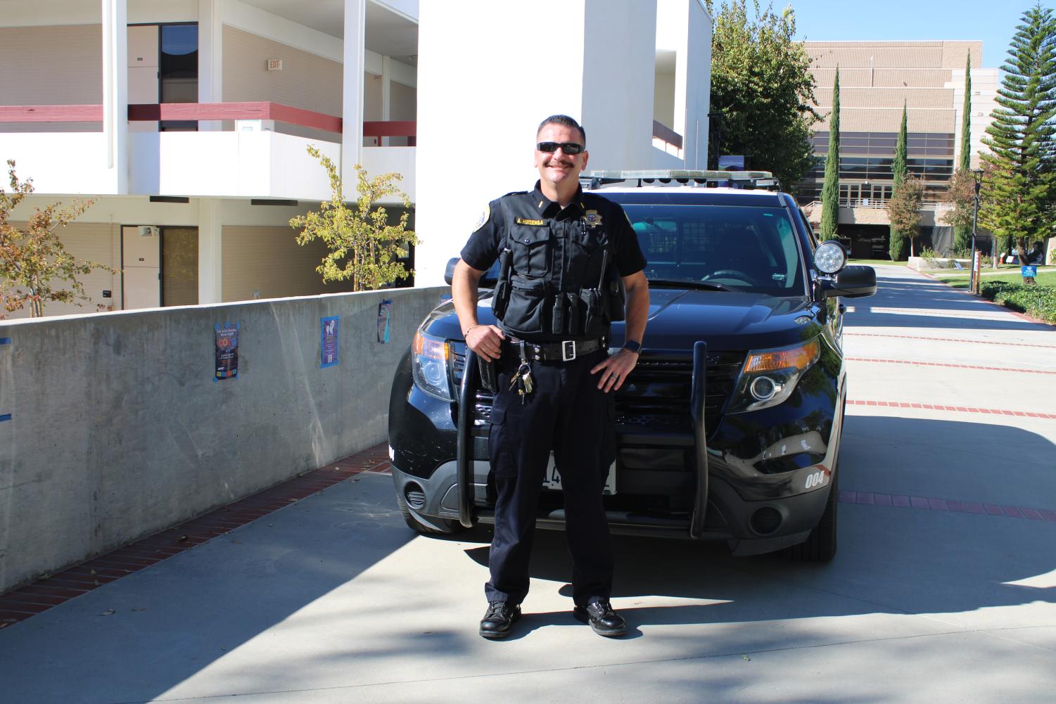Lieutenant Andrew Huisenga poses in front of a Police car on the main campus of Moorpark College on Nov. 15. IDK what to say for a second sentence help me out here.