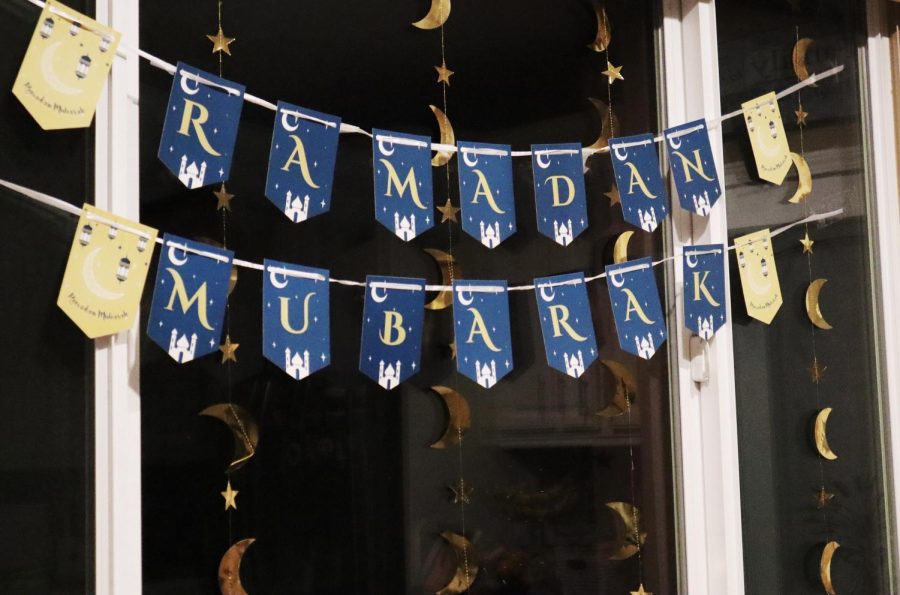 A banner hanging in front of celestial decorations reads Ramadan Mubarak on March 31, 2022. The phrase welcomes the month-long tradition of fasting and reflection. Photo Credit: Shahbano Raza