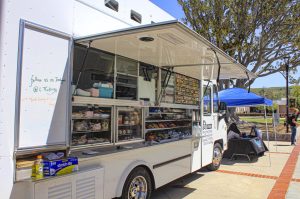 L&T Catering food truck next to the ASMC Bluesday Booth at the Moorpark College on April 5, 2022. The ASMC booth gave tickets to students who were wearing blue so they could have a free meal from the food truck. Photo credit: David Chavez