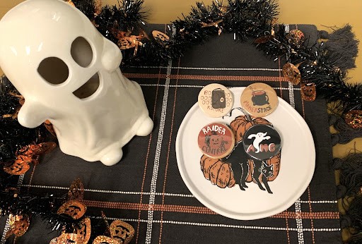 Moorpark College themed buttons are displayed next to the Associated Students of Moorpark Colleges Halloween decorations. These same buttons will be passed out on Oct. 31, 2022 at ASMCs Halloween Festival. Photo credit: Jasmine Hallack