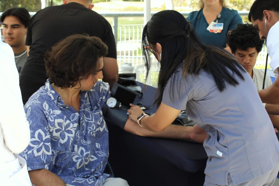 Venice Torres, a first-year nursing student at Moorpark College takes Micah Hojos blood pressure at the annual Health Fair on Oct. 4. Photo credit: Sarah Graue