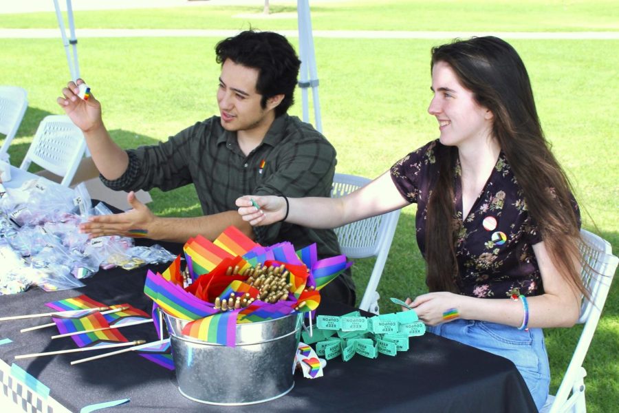ASMC Director of Student Organizations Sergio Mendieta and ASMC Director of Student Services Alette Laughton hand out buttons, mini-flags and free food tickets to attendants of the Moorpark College Pride Fair on Oct. 11, 2022. Photo credit: Sarah Graue