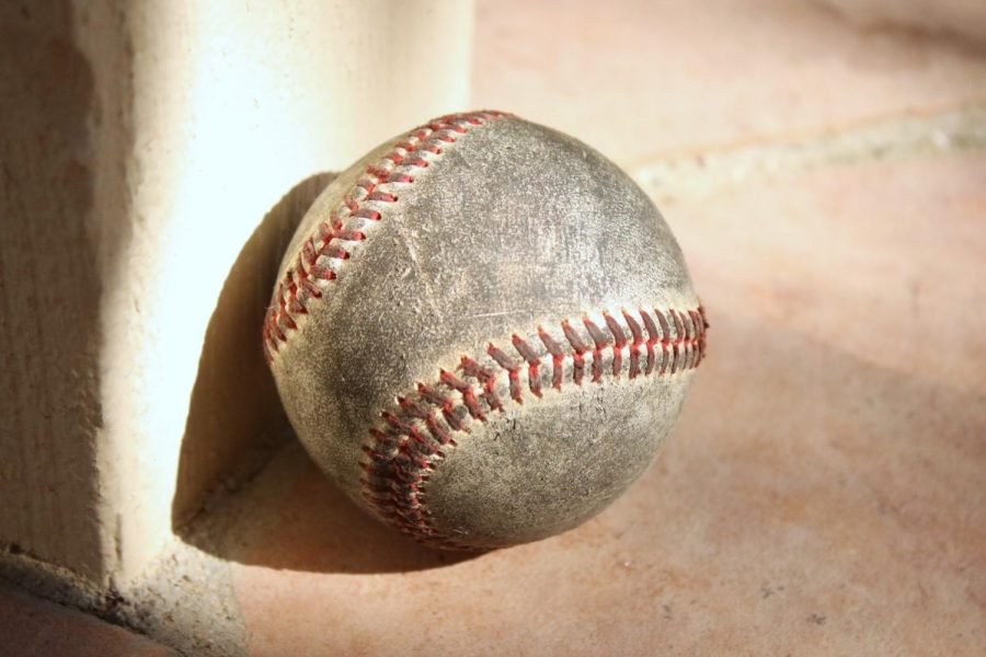 A used baseball rests against a lamp post at a park in Simi Valley, CA. Photo credit: Briana Cruz