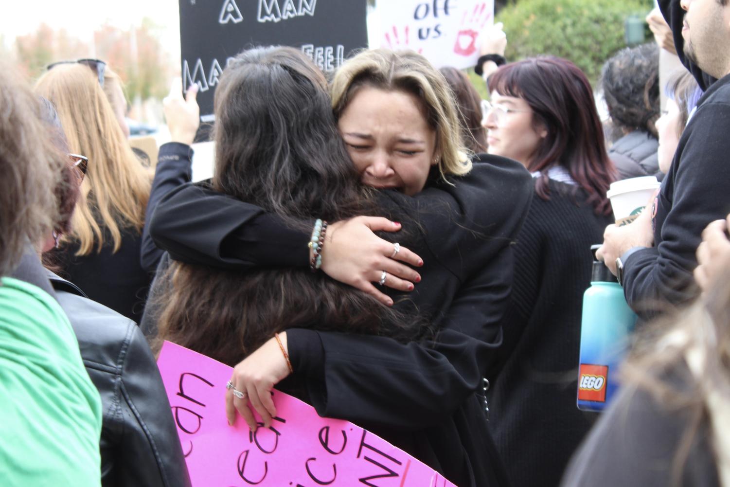Leader and coordinator of the protest, Isa Rojas, embraces a fellow protestor after delivering a heartful speech to the crowd on Dec. 15, 2022.