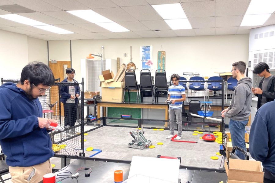 The+Moorpark+College+Engineering+Club+tests+a+larger+robot+in+a+replica+of+the+2022-2023+Vex+Robotics+arena%2C+which+the+club+purchased+and+has+been+able+to+use+throughout+the+year+in+order+to+prepare+for+competitions.+Photo+credit%3A+Gabriel+Sanchez-Rivera