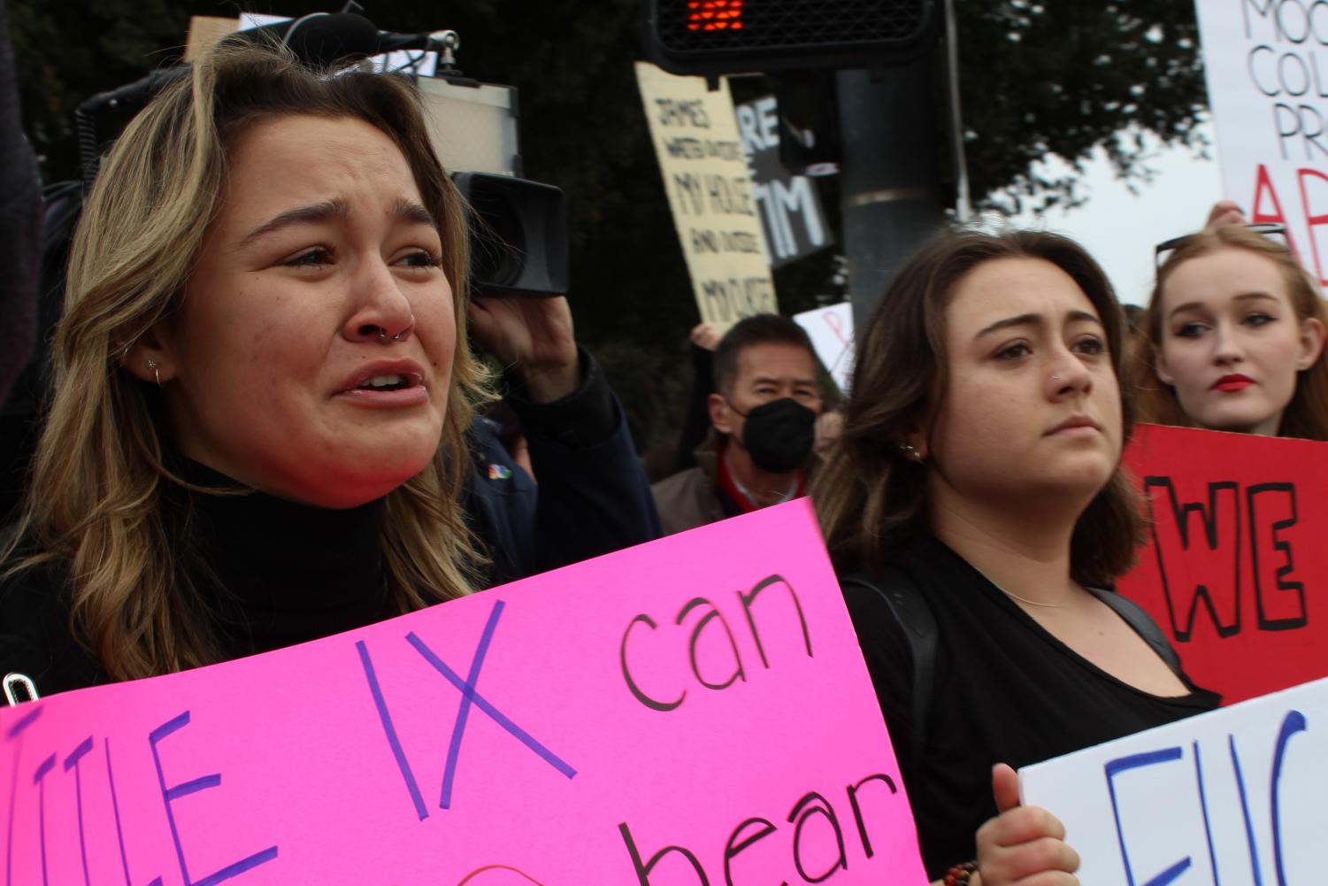 Moorpark College students Isa Rojas, Oliva Vasquez and Ella Boring hold up signs protesting Title IX ineffectiveness and the college administration on Dec. 15, 2022. The protest took place just outside the college campus at the intersection of Collins Drive and Campus Drive in Moorpark, CA.