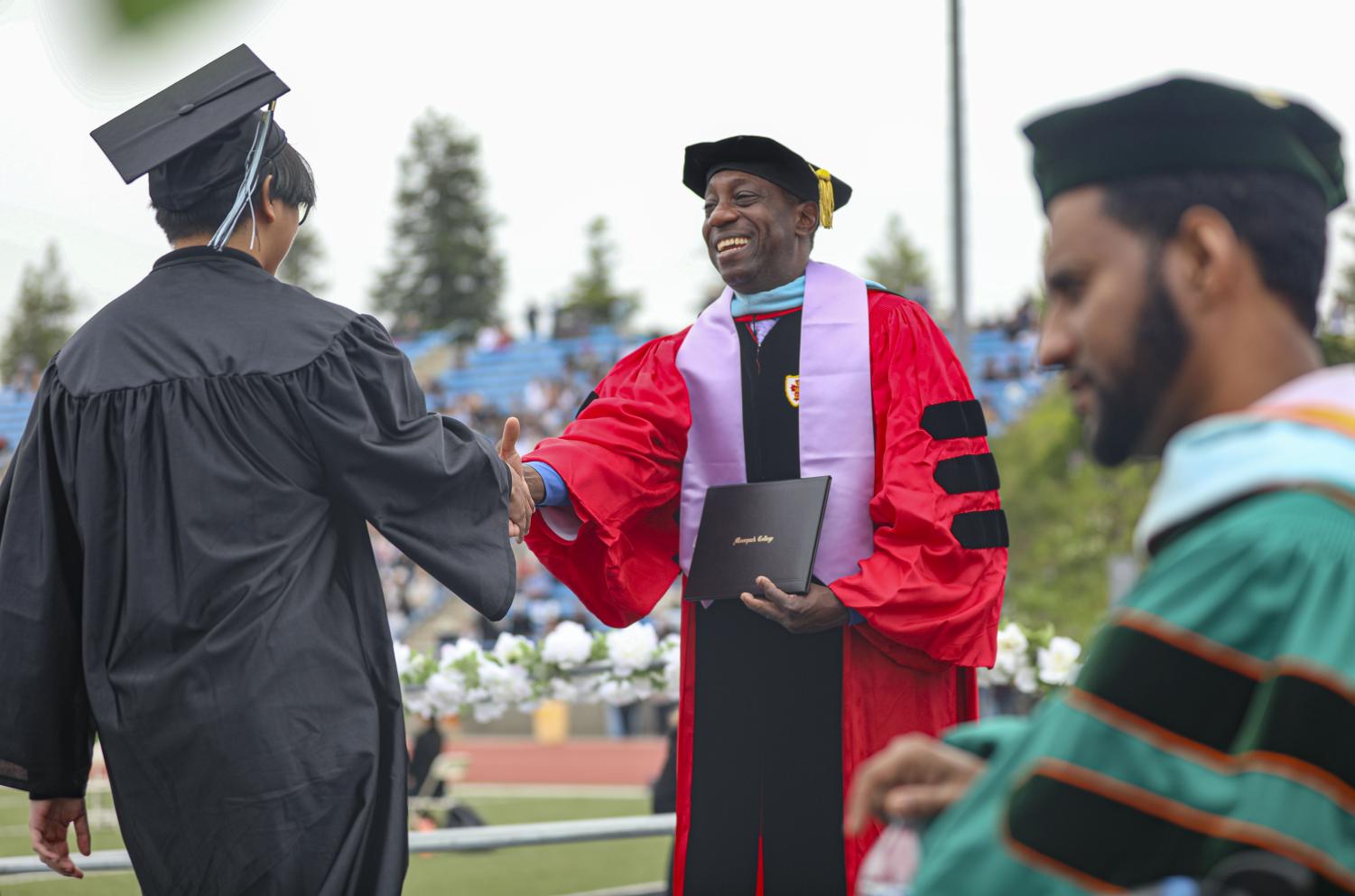 Moorpark College President Julius Sokenu shakes hands with a graduating student while presenting diplomas to the class of 2023 on Friday, May 19 in Moorpark, CA.