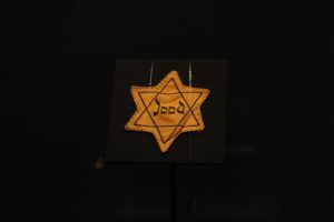 A yellow Star of David patch worn to identify Jewish people in WWII Europe on display at the Ronald Reagan Presidential Librarys Auschwitz exhibit. Photo credit: Jaya Roberts