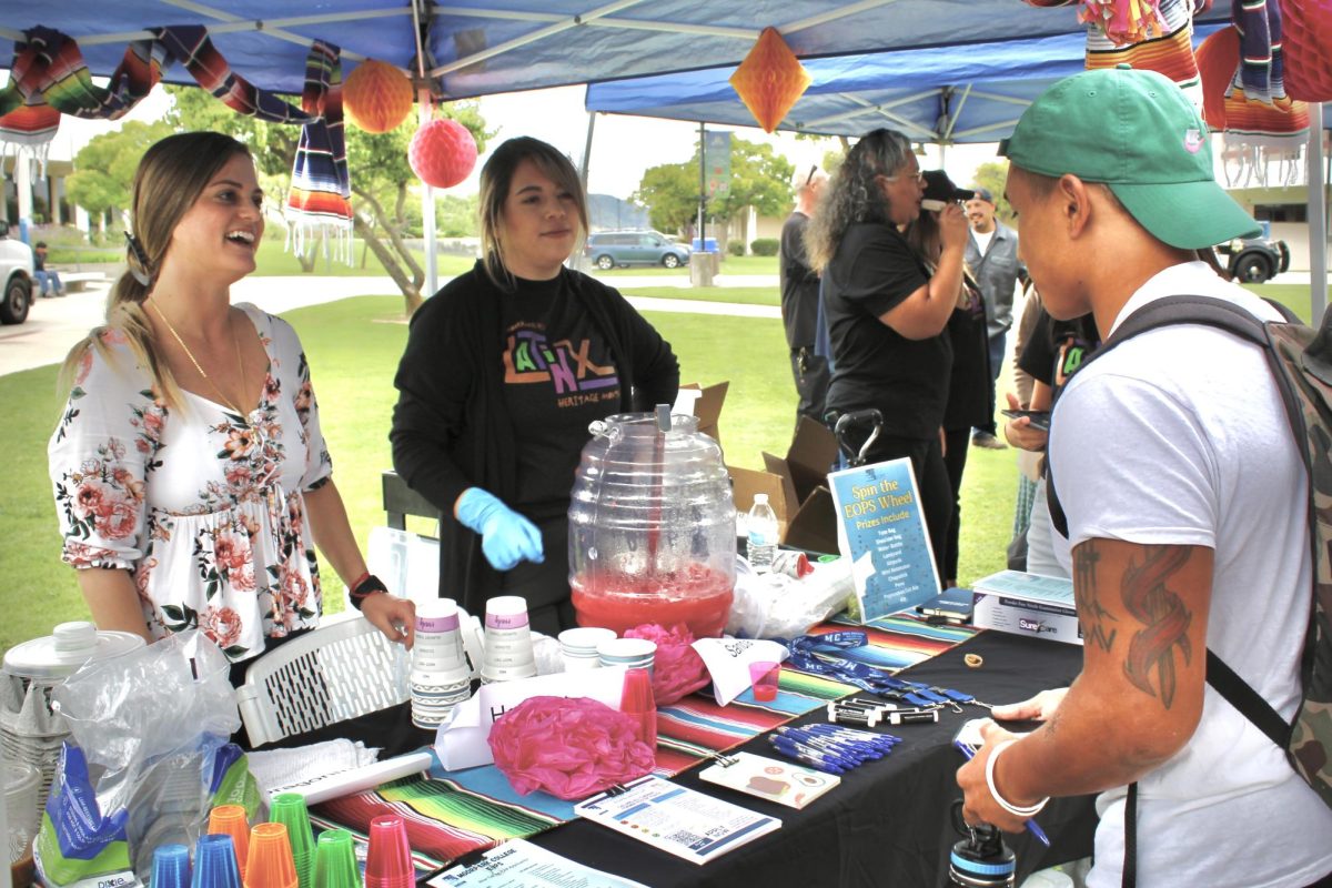 Gianna Mannarino and Veronica Ramirez of Extended Opportunity Programs and Services at Moorpark College converse with students at their booth at the Latinx Heritage Month Kick-off Event on Sept. 20, 2023. Photo credit: Sarah Graue