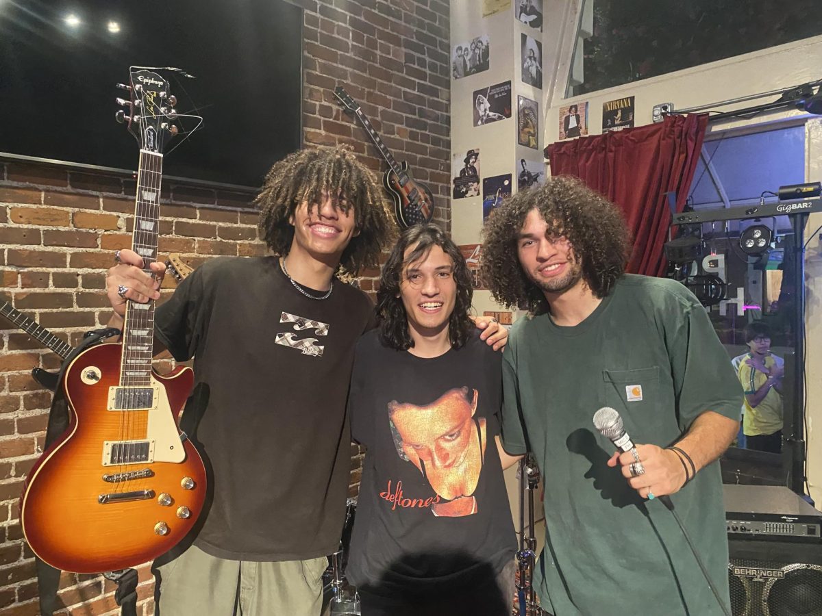 Spirit Bonewitz (left), Julian Fricilli (middle) and True Bonewitz (Right) pose onstage at The Pour House in Monrovia, California on Sept. 1, 2023. Both Bonewitz brothers attend Moorpark College. Photo credit: Pierre Michelet
