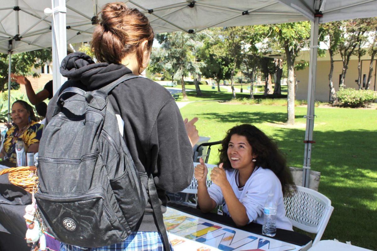 Julianna Kent, the treasurer and creative director of Latinx Club, interacts with prospective club remembers at Club Rush on Sept. 26, 2023. Photo credit: Brianna Perez
