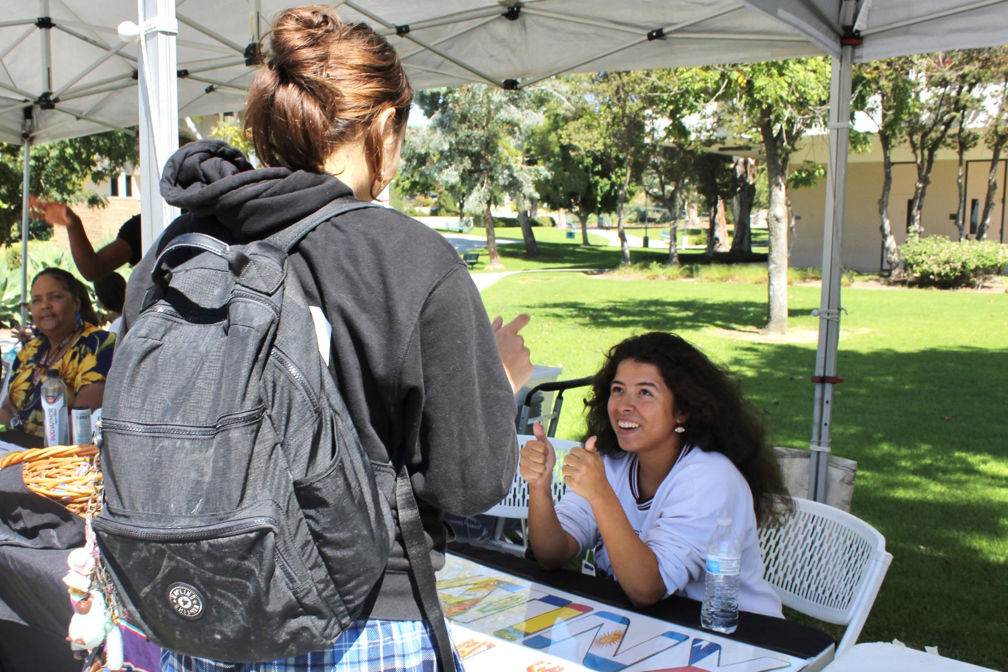 Julianna Kent, the treasurer and creative director of Latinx Club, interacts with prospective club remembers at Club Rush on Sept. 26, 2023.