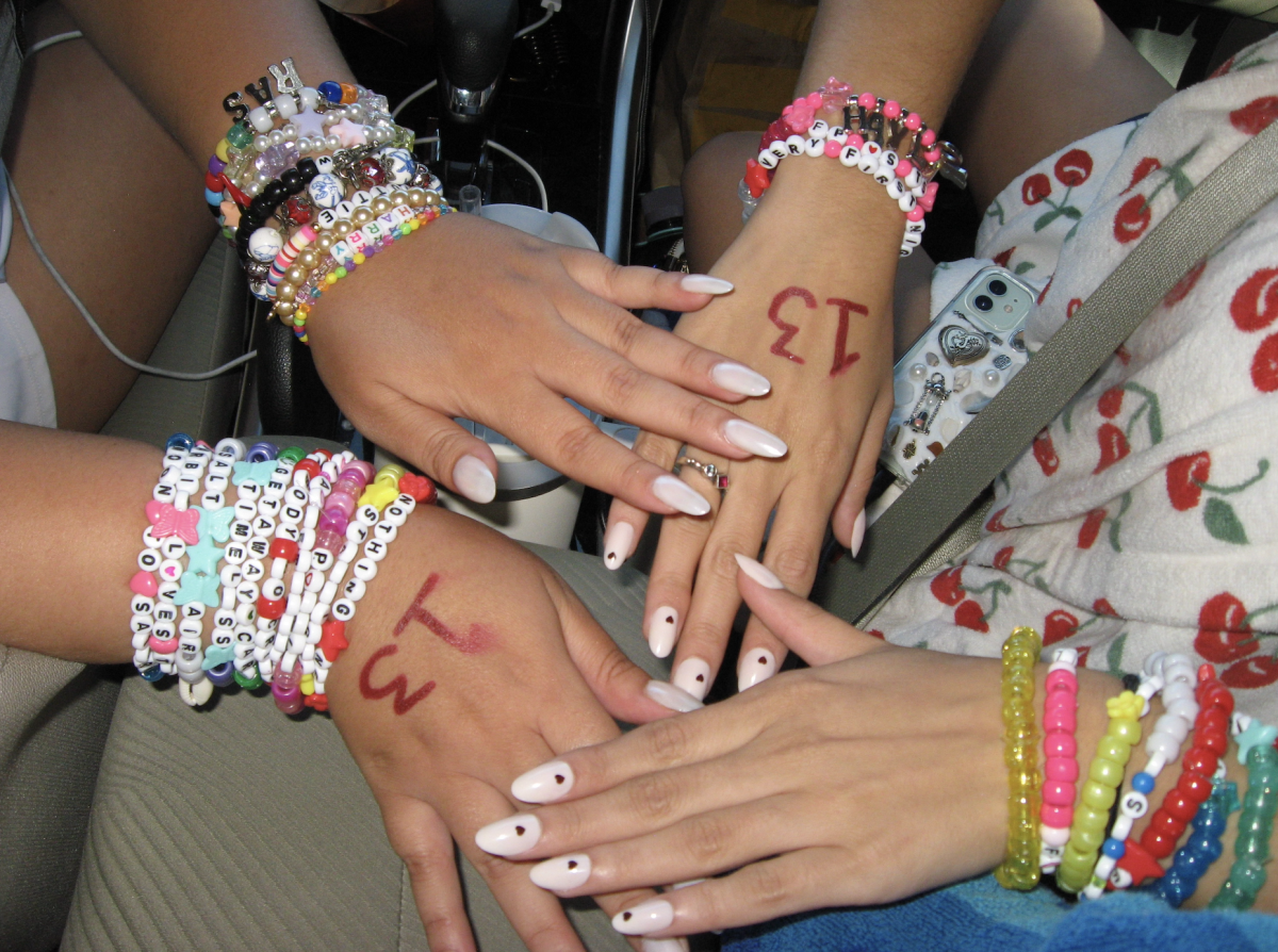 Swifties show off their handmade friendship bracelets before attending The Eras Tour at SoFi Stadium on Aug. 3, 2023. Photo credit: Jaya Roberts