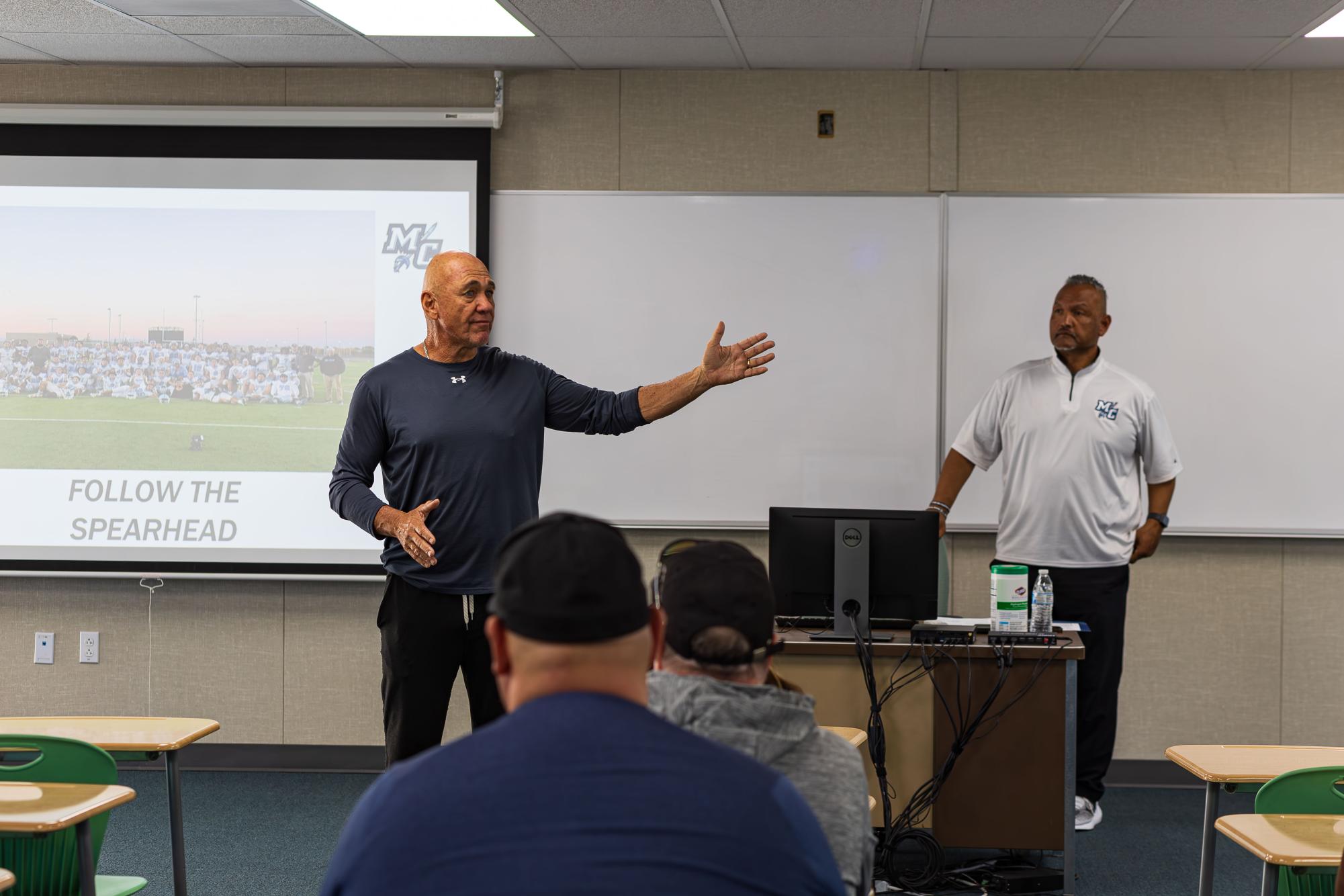 (From left to right) Coaches Phil McPherson and John Diaz speaking to the parents of the new football players on February 24th 2024 at the Moorpark Griffin Stadium during the Meet and Greet by Chris Pineda