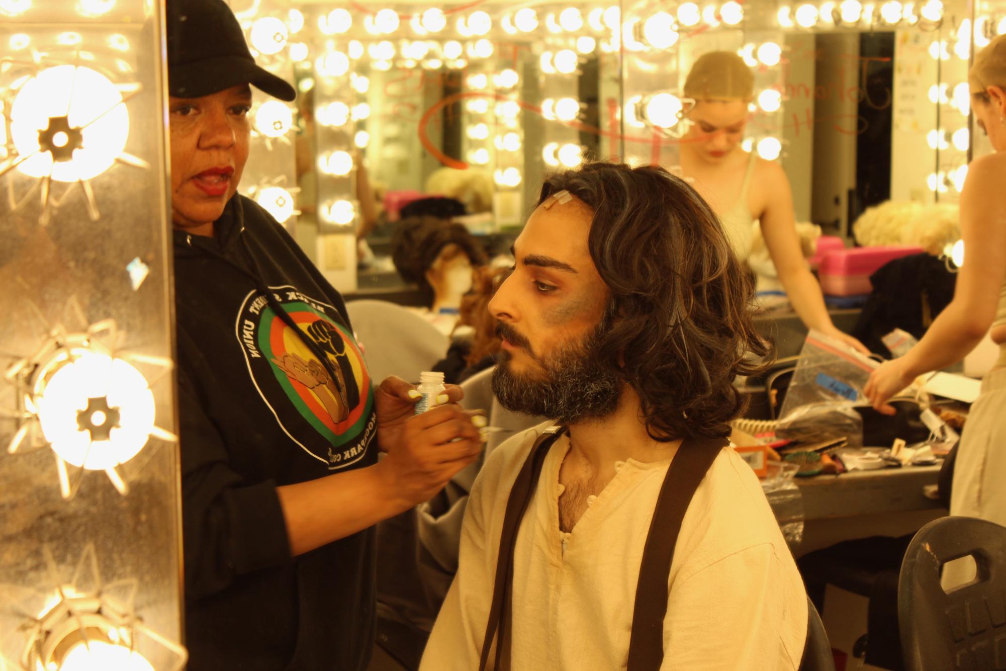 Hair/Wig Designer J&squot;enyce Johnson putting the finishing touches on Trevor Alkazian&squot;s appearance before the premiere of "Sweeney Todd: The Demon Barber of Fleet Street."