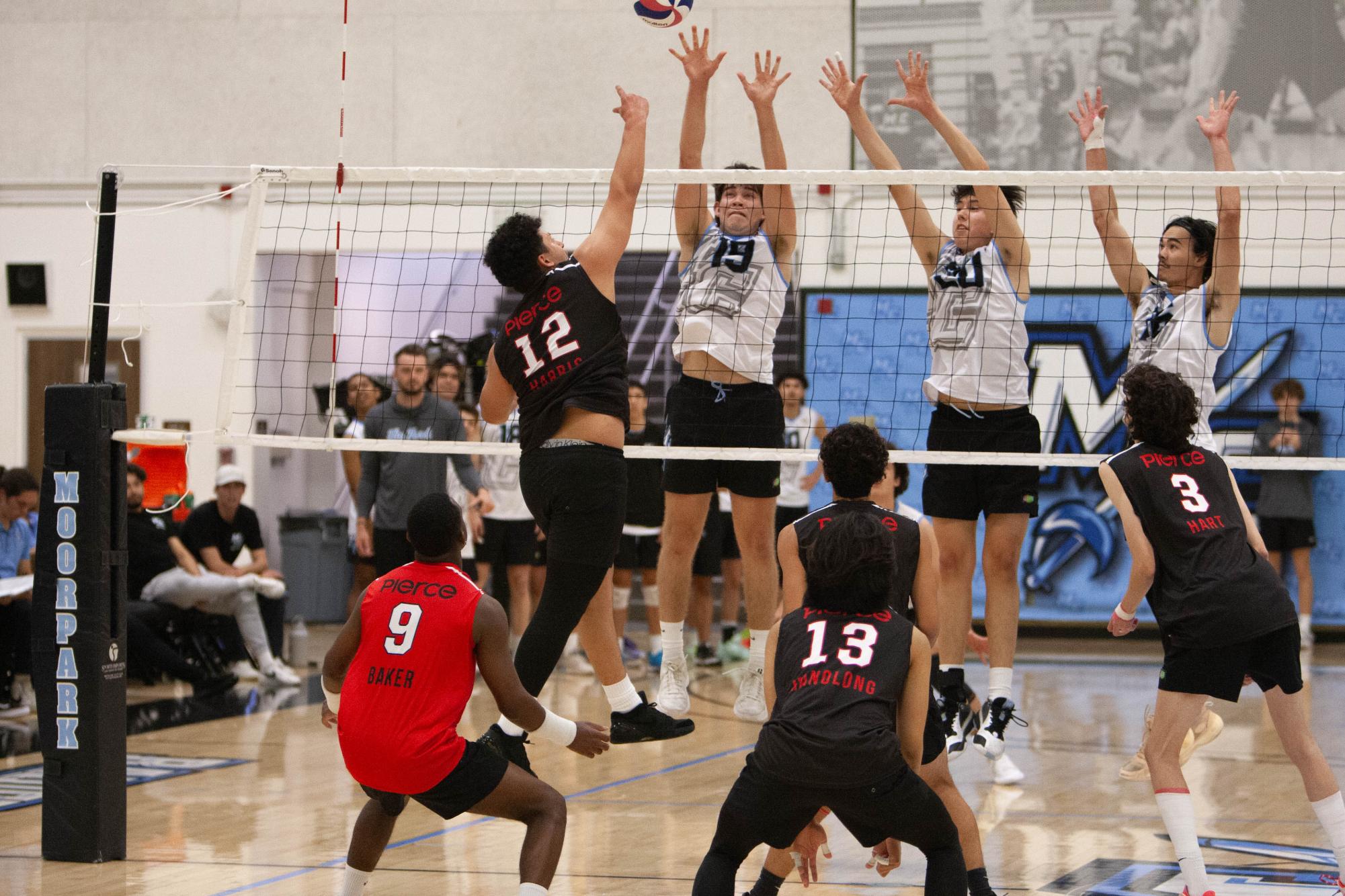 Brahmas Outside Hitter Vincent Harris attempts to hit through a wall created by the Raiders triple block comprised of Taylor Phipps (19), Brandon Baez (20), Kaipono Benson (16), during the match played at Moorpark College on Wednesday, March 13, 2024, Moorpark, Calif. Photo credit Jimmy Jacobs.