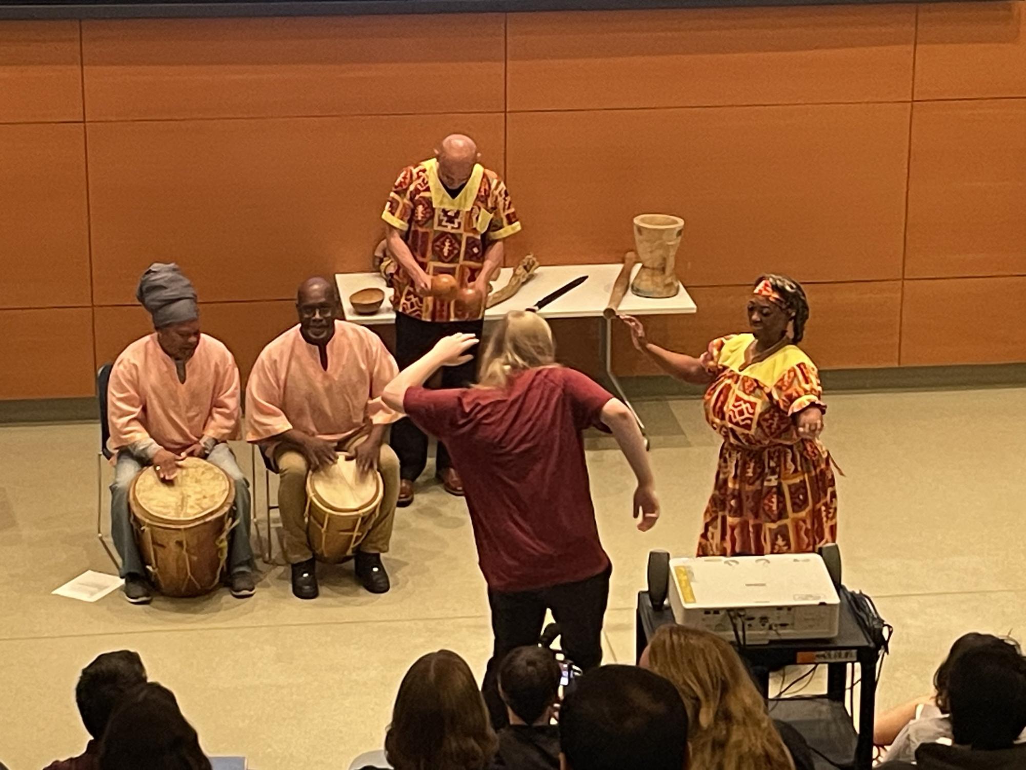 An audience member joining in on Noralez-Figueroa's traditional performance.