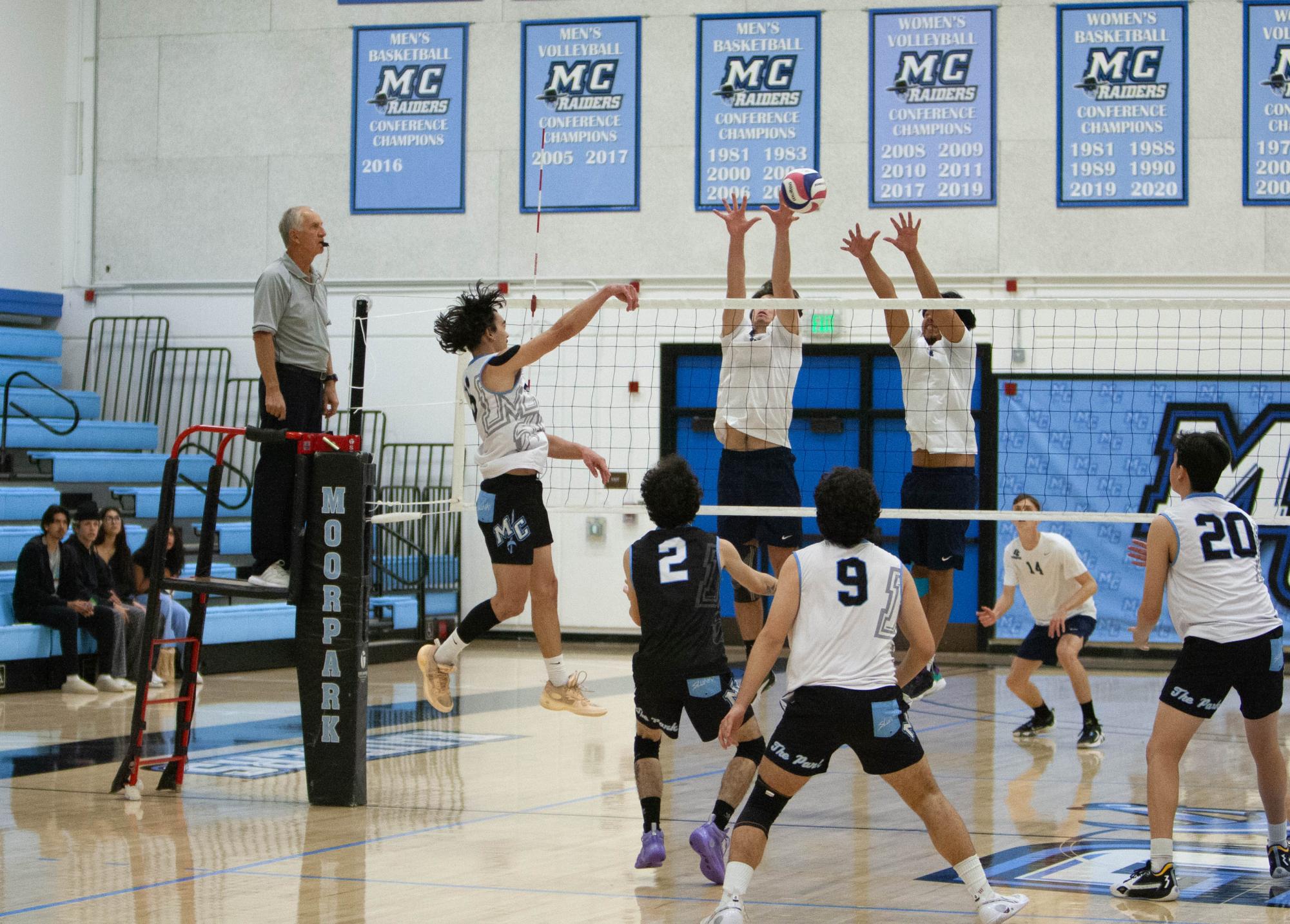 Moorpark Outside Hitter, Kaipono Benson (16), hits over the block while teammates Braden Gonzales (2), Merit Ghodrat (9), and Brandon Baez (20) look on during Moorpark College men's volleyball match against El Camino College at Moorpark, Calif. on March 6, 2024. Photo Credit Jimmy Jacobs.