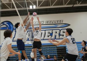 Setter Merit Ghodrat (9), Moorpark, draws two El Camino blockers with a jump set to Brandon Baez (20) while Libero Braden Gonzales (2) covers the middle of the court during play at Moorpark College on March 6, 2024 at  Moorpark, Calif. Photo credit: Jimmy Jacobs