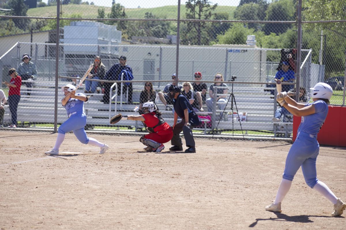 Moorpark College infielder #20 Isabella Velasquez punishes a softball as teammate #9 Maddy Mekari gets her timing down in the on-deck circle on April 18, 2024. Photo credit: Clayton Byrne