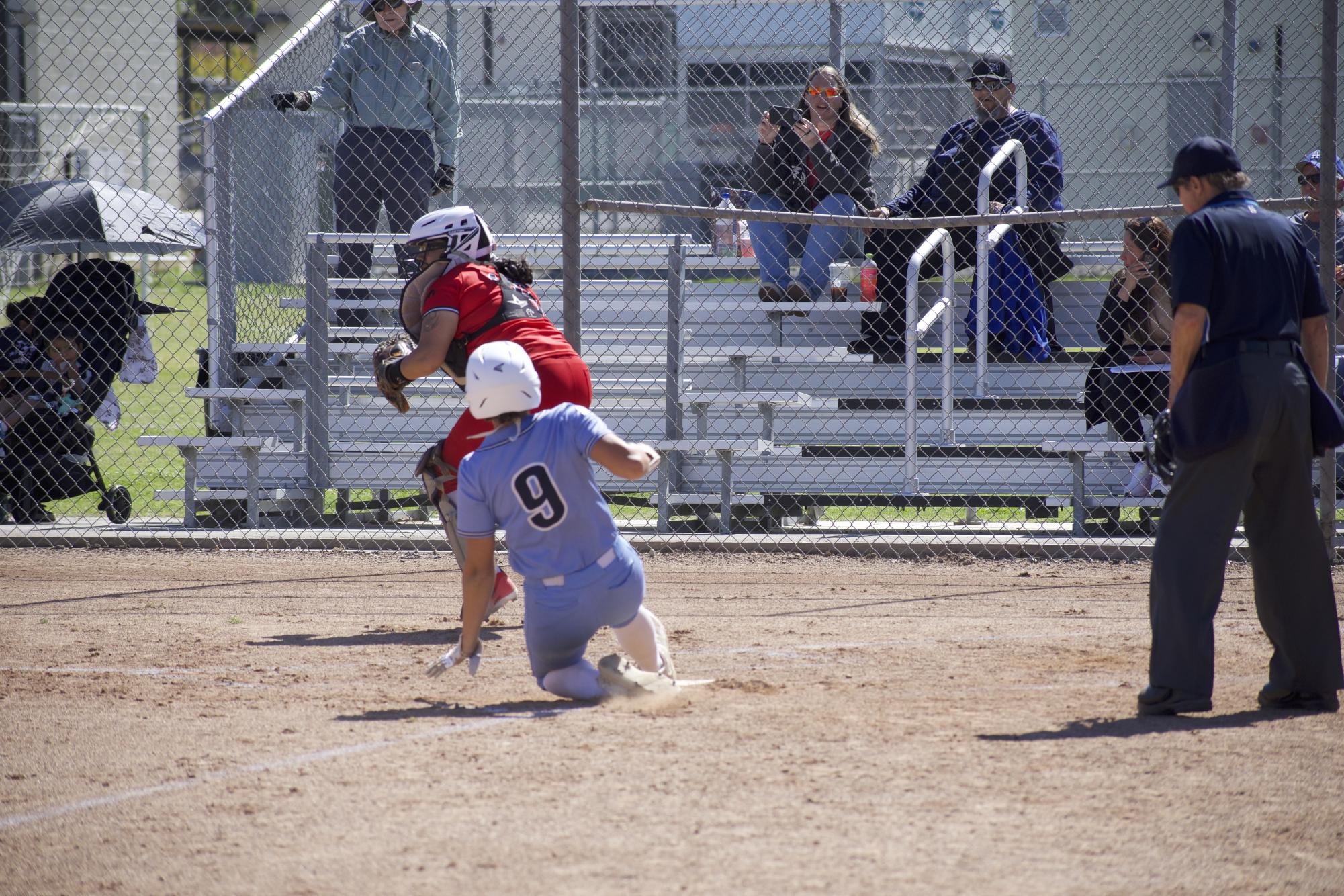 Raiders catcher #9 Maddy Mekari slides into home plate to extend the Moorpark lead over Pierce on April 18, 2024.