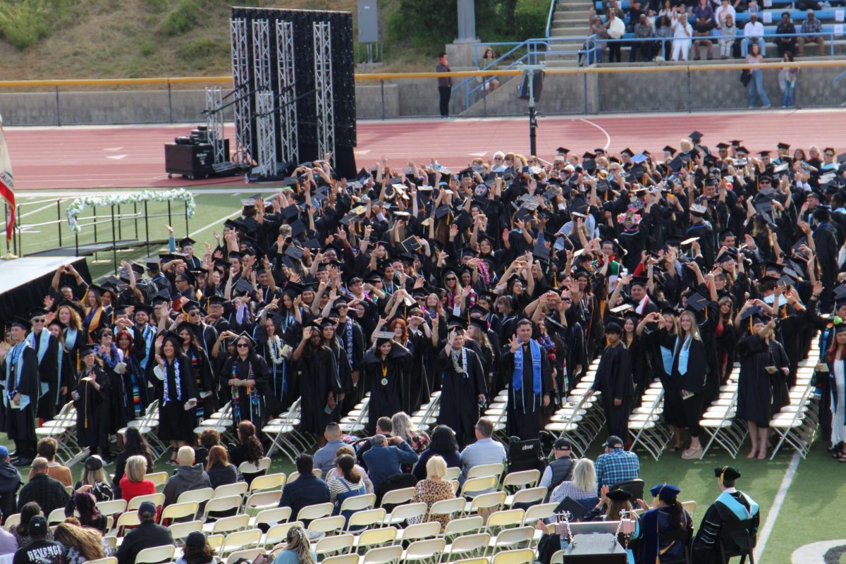 The Moorpark College Class of 2024 waves to loved ones in the stands of Griffin Stadium during the evening commencement ceremony on May 17, 2024. Photo credit: Sarah Graue