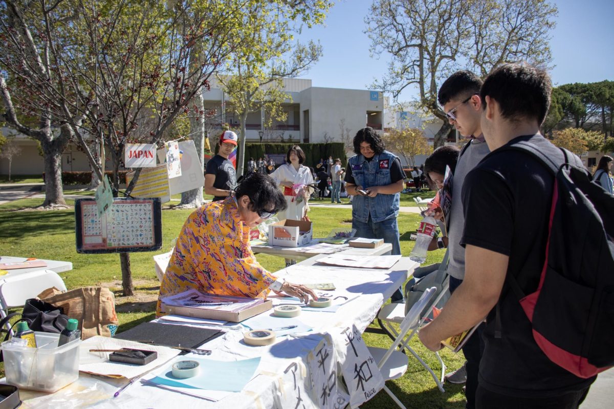 Volunteer writes students names in Japanese at Moorpark Colleges Multicultural Day on April 9, 2024. Photo credit: Madeleine Kukucka
