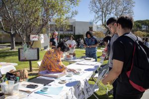 Volunteer writes students' names in Japanese at Moorpark College's Multicultural Day on April 9, 2024. Photo credit: Madeleine Kukucka