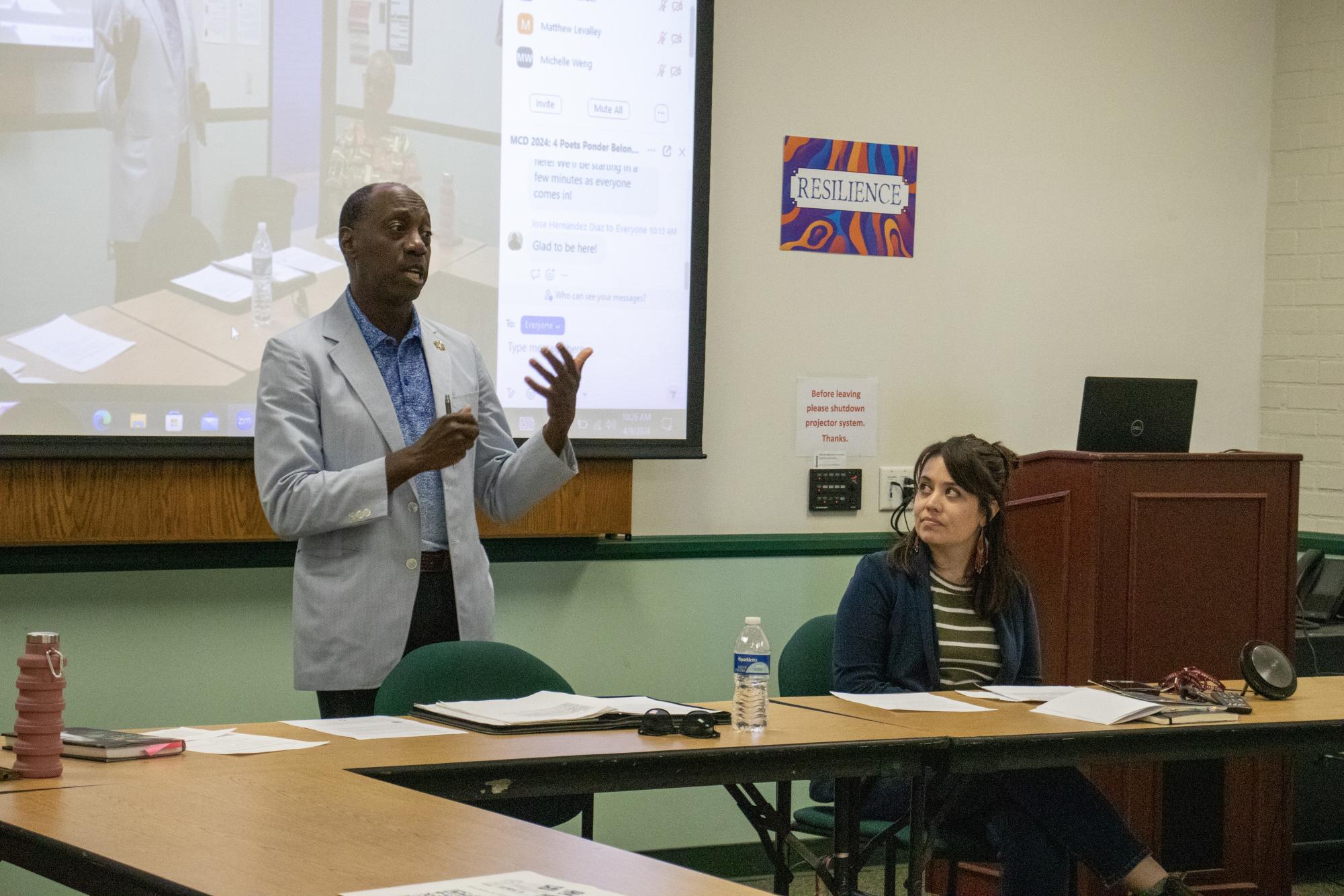 Dr. Julius Sokenu (left) speaks about his inspiration for writing poems and his life during "4 Poets Ponder Belonging in the Diaspora" at Moorpark College during Multicultural Day on April 9, 2024.