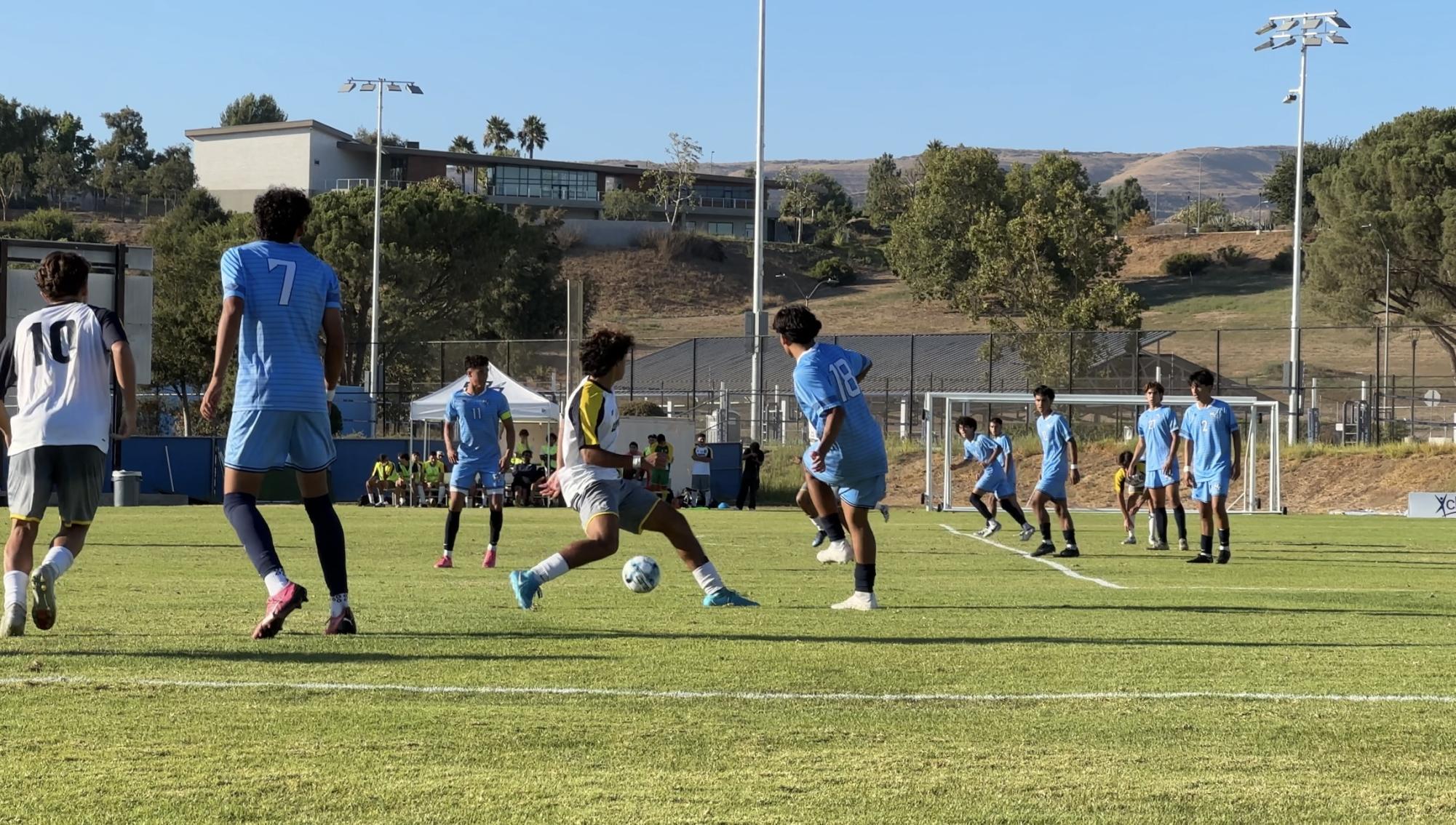 “#18 sophomore Andrew Cruz passes to #11 freshman Diego Estrada in Moorpark, Calif. on Tuesday, Aug. 27, 2024”