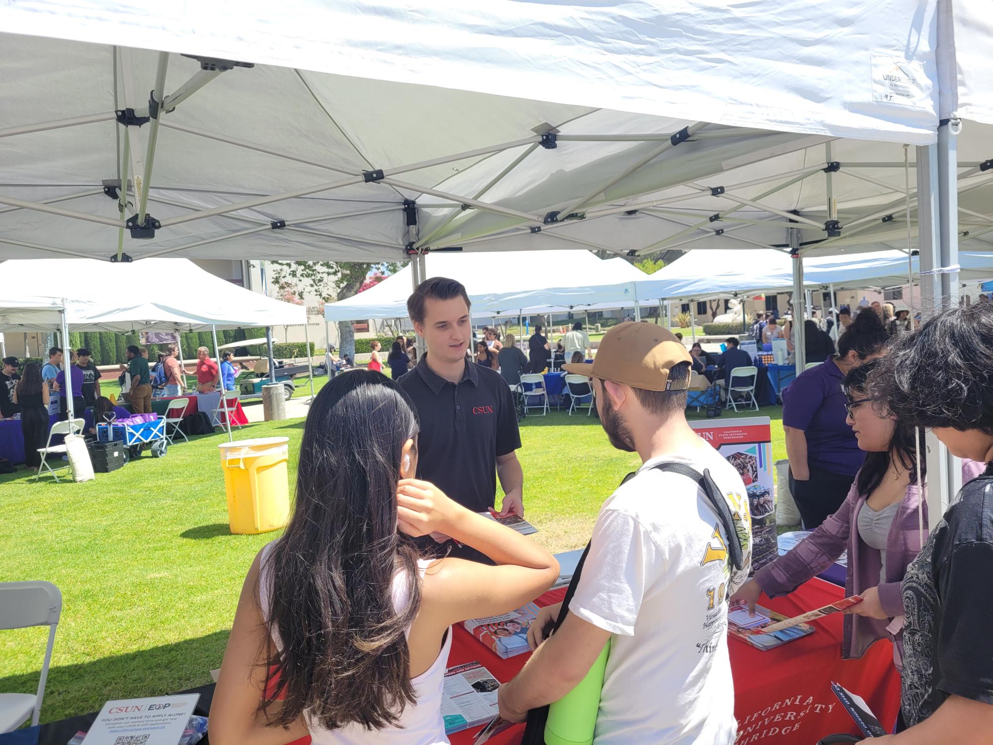 Moorpark College students speak with a representative from California State University, Northridge in Raider Walk for Moorpark College's Transfer Event on Thursday, Aug. 29, 2024 in Moorpark, Calif.