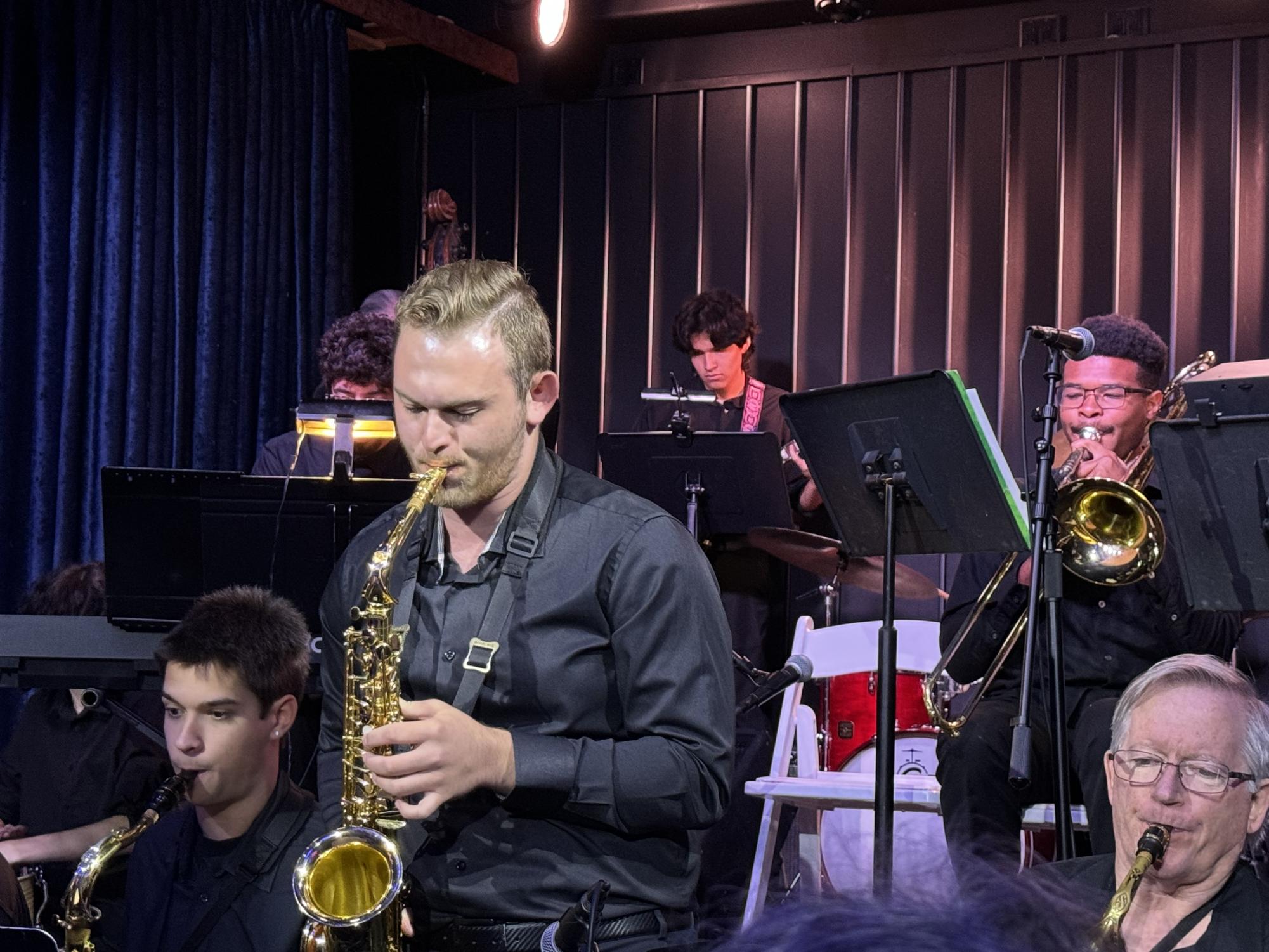 Ariel Hoffman (Center) performing his saxophone solo to the audience at Bar Louie in Westlake, Calif. on Sunday, September 22, 2024