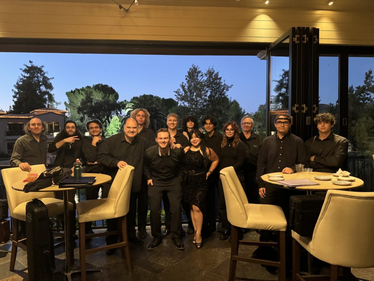 Moorpark's A and B band members posing   for a group photo with professor Brendan McMullin at Bar Louie in Westlake Village, Calif, on Sept. 22, 2024. Photo credit: Pierre Michelet