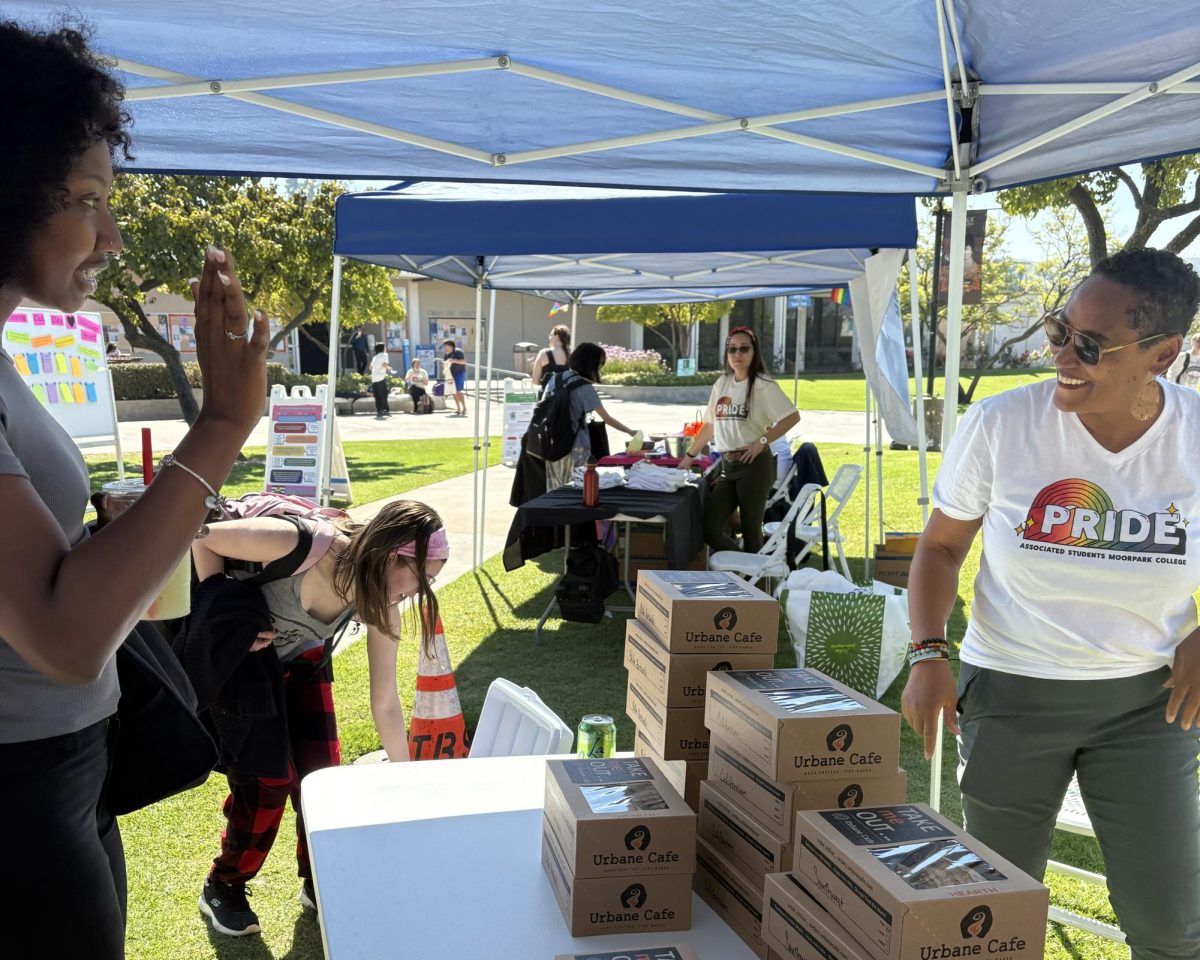 Associate Dean of Diversity Tamarra Coleman greets and shares a smile when passing out food to students during the National Coming Out Day celebration on Wednesday, Oct. 9, 2024 in Moorpark, Calif. Photo credit: Danielle De Leon