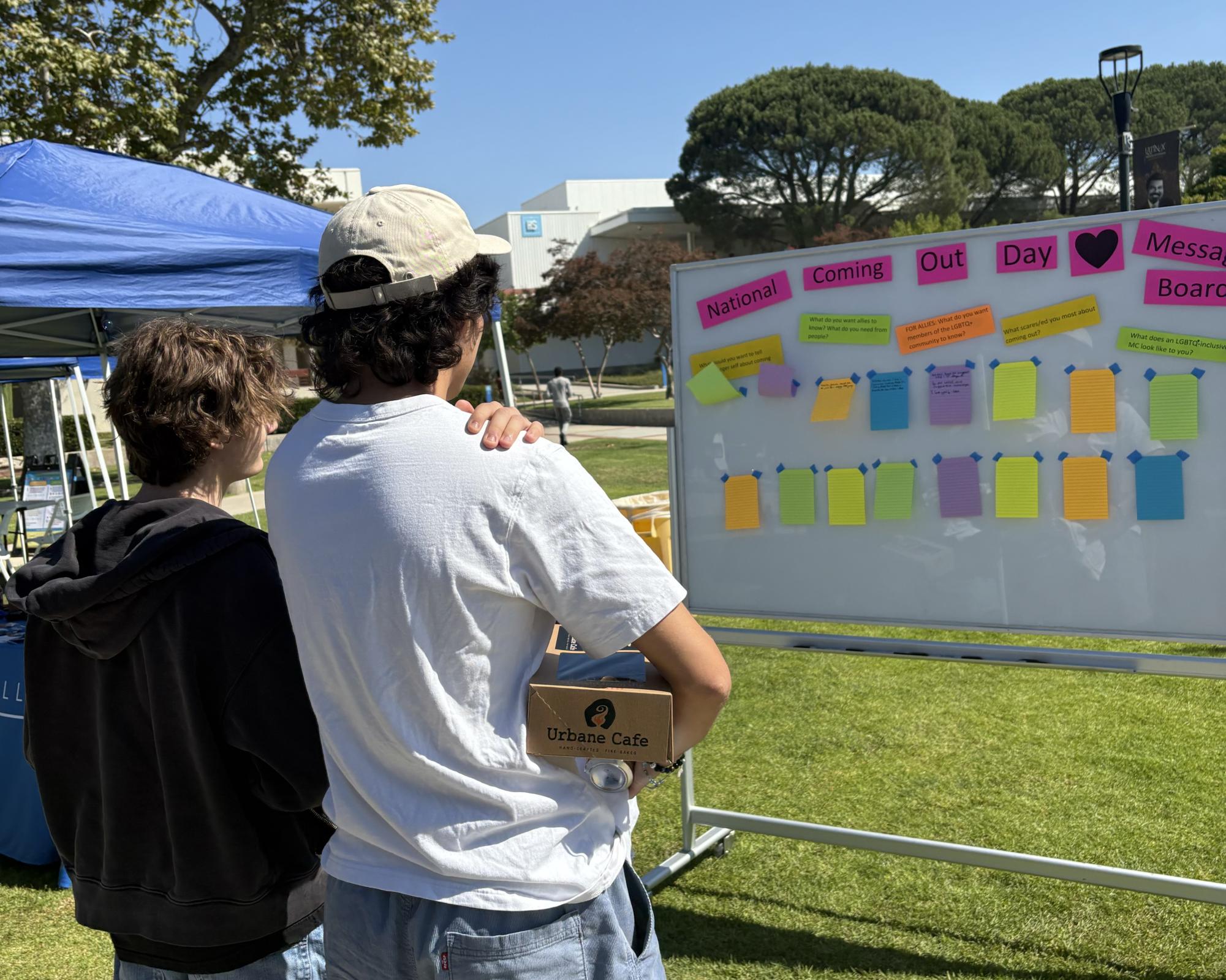 Students read friendly messages to other fellow students on the National Coming Out Day board on Raider Walk on Wednesday, Oct. 9, 2024 in Moorpark, Calif.