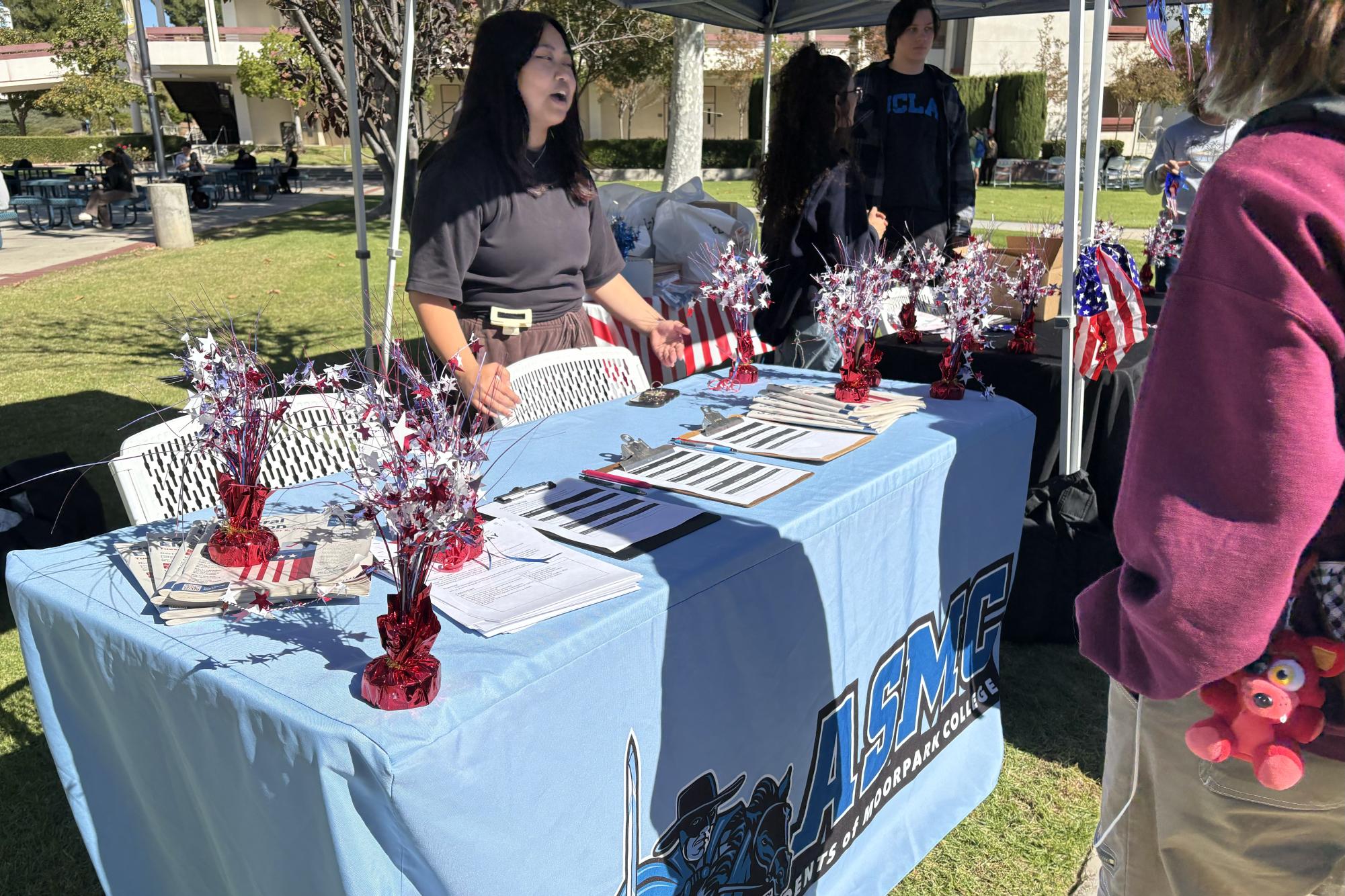 ASMC representatives present debate sign-up sheets and voter ballot packets with information on voting procedures along the pathway of the quad on Monday, Nov. 4, 2024 in Moorpark, Calif.