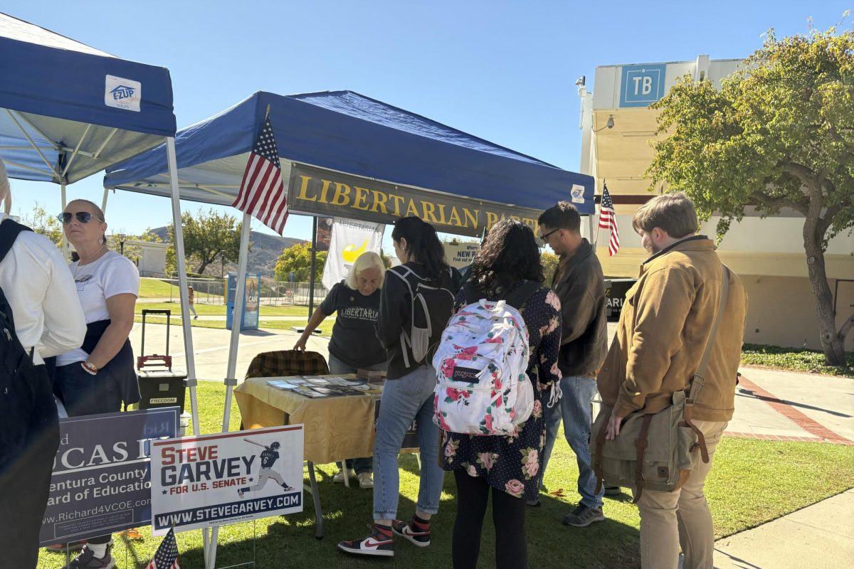 Students visit with the Libertarian Party Representative and information booth along the pathway of the quad on Monday, Nov. 4, 2024 in Moorpark, Calif. Photo credit: Danielle De Leon