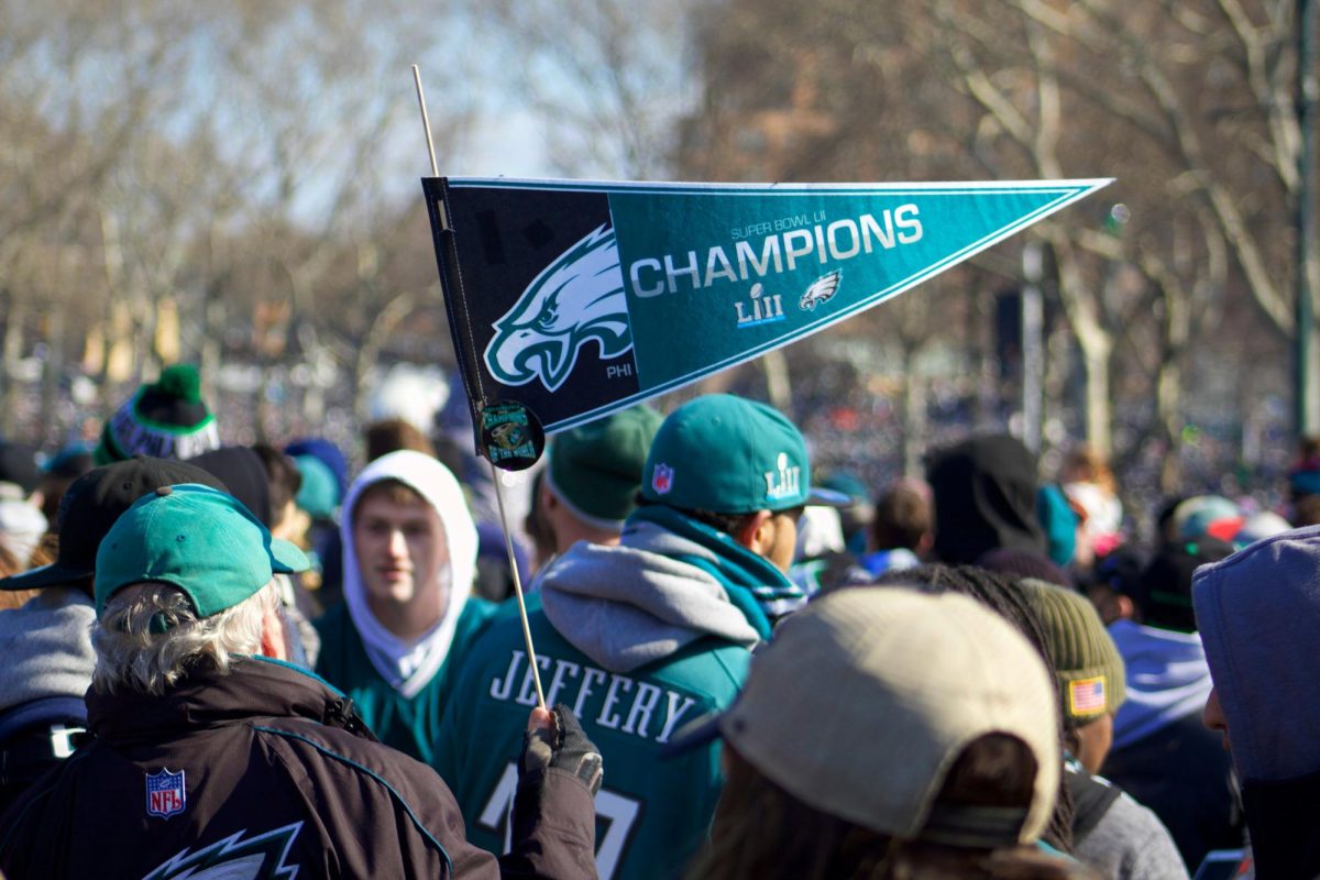 A Philadelphia Eagles fan poses with a Championship flag from Super Bowl LIII. The Eagles went on to win Super Bowl LIX on Feb. 9, 2025. Photo credit: Unsplash