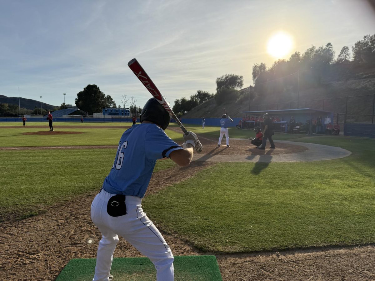 Moorpark College infielder #16 Michael Rizzoti warms up on deck in the bottom of the ninth inning on Saturday, Feb. 22 in Moorpark, Calif. Photo credit: Jackson Herrguth