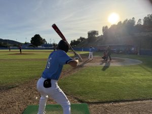 Moorpark College infielder #16 Michael Rizzoti warms up on deck in the bottom of the ninth inning on Saturday, Feb. 22 in Moorpark, Calif. Photo credit: Jackson Herrguth