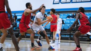 Moorpark College men's basketball freshman forward Isaiah Sherrard weaves through the opposing team to get to the basket in a home battle in the Moorpark College gym during the 2025 season. Photo credit: Felipe Araneda