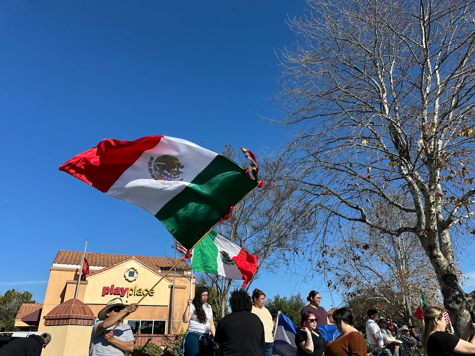 Protesters Waving Mexican, El Salvador, and American Flags